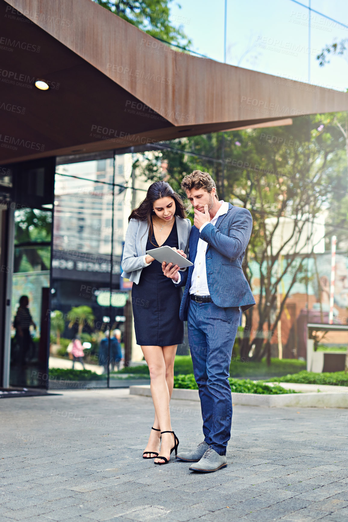 Buy stock photo Businessman, woman and tablet in city for planning, brainstorming or discussion on sidewalk. Corporate team, tech or thinking at office building for feedback, company review or networking in New York