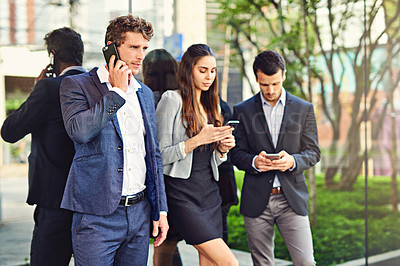 Buy stock photo Cropped shot of businesspeople using cellphones outside