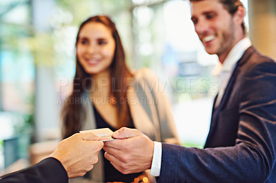 Buy stock photo Cropped shot of a businessman and businesswoman checking into a hotel