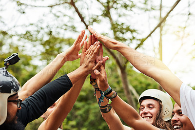 Buy stock photo Cropped shot of a group of friends high-fiving outdoors