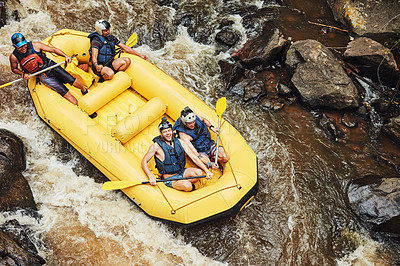 Buy stock photo Shot of a group of friends out river rafting on a sunny day