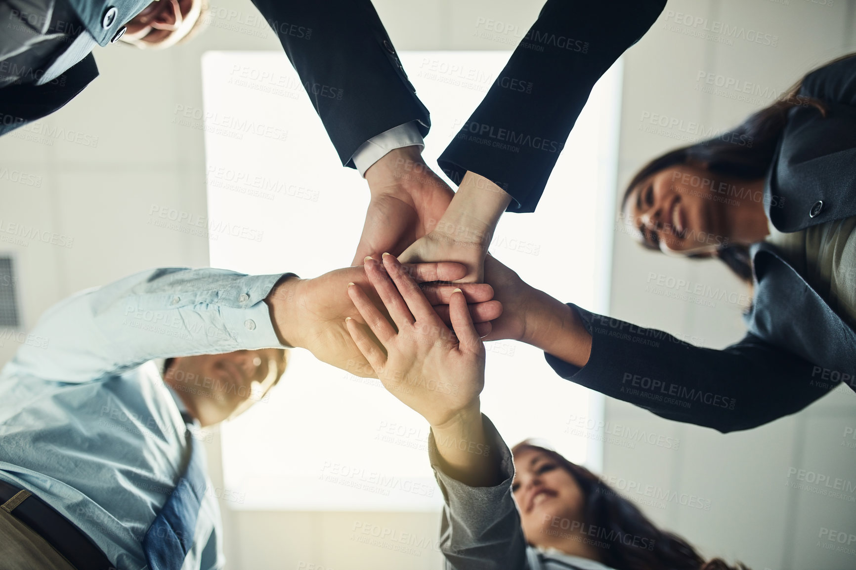 Buy stock photo Cropped shot of a group of businesspeople joining their hands in solidarity