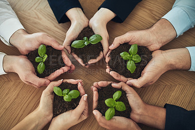 Buy stock photo Cropped shot of a group of businesspeople holding plants growing out of soil
