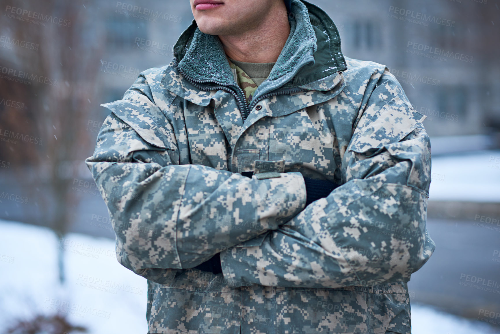 Buy stock photo Cropped shot of a young soldier standing outside on a snowy day at military school
