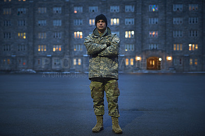 Buy stock photo Shot of a young soldier standing outside on a cold day at military school