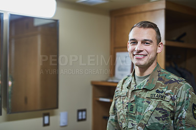 Buy stock photo Shot of a young soldier standing in the dorms of a military academy