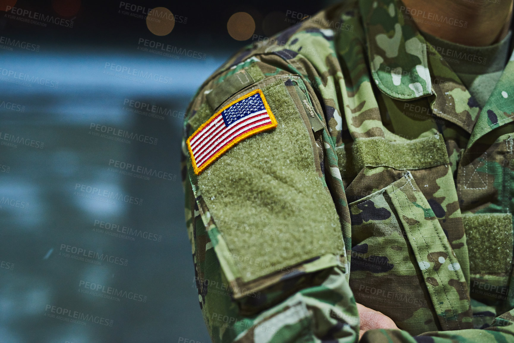 Buy stock photo Cropped shot of a soldier wearing camouflage fatigues with an american flag for a patch