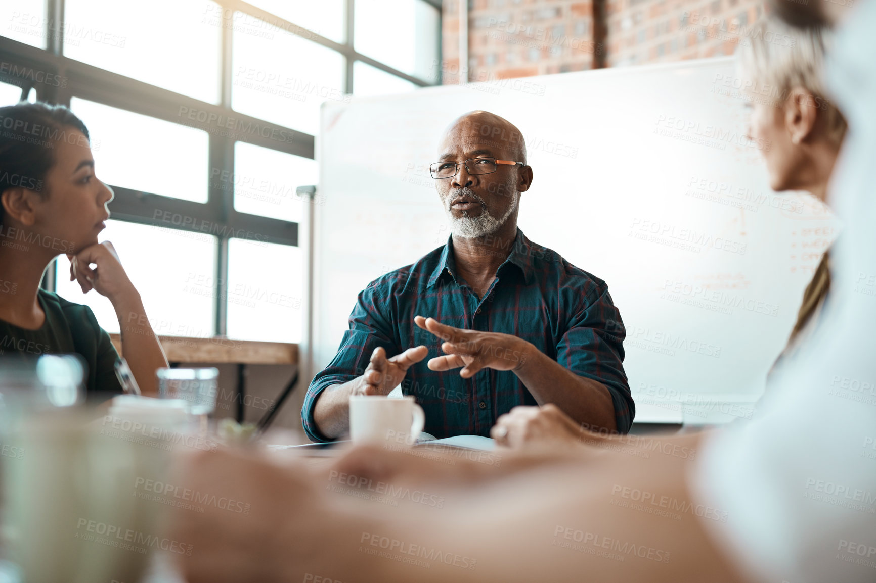 Buy stock photo Meeting, business people and leadership of black man in office, talking or speaking. Teamwork, ceo and senior African male professional brainstorming, collaboration or planning group strategy at work