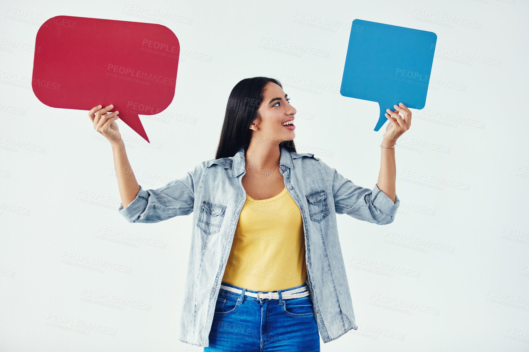 Buy stock photo Studio shot of an attractive young woman holding speech bubbles