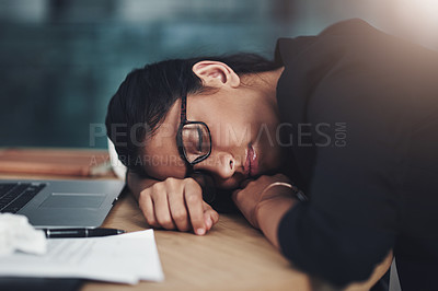 Buy stock photo Shot of a young businesswoman sleeping at her desk while working in an office