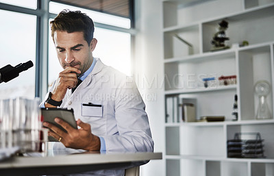 Buy stock photo Shot of a scientist using a digital tablet while working in a lab