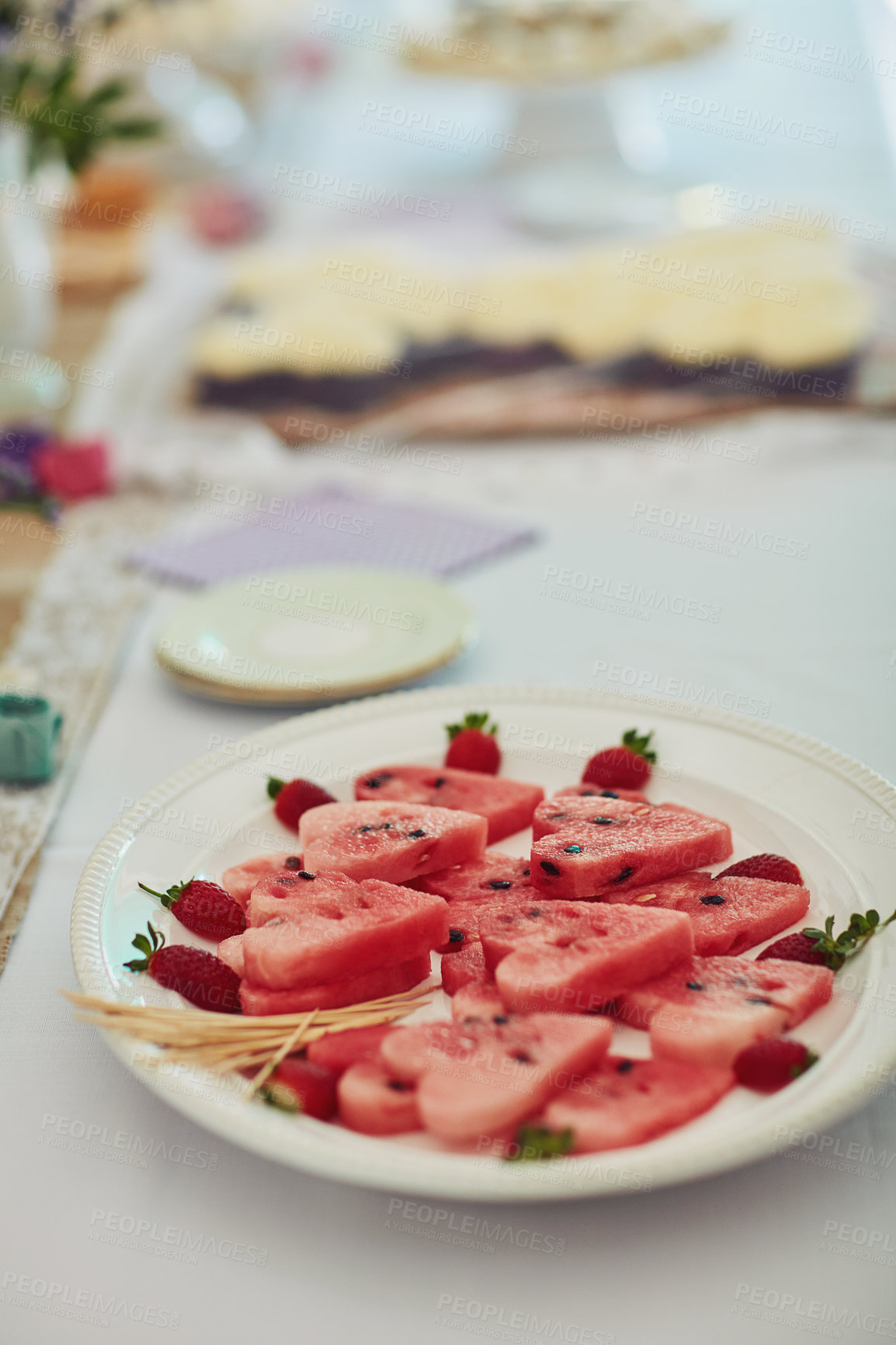 Buy stock photo Shot of watermelon cut into heart shapes on a table at a tea party inside