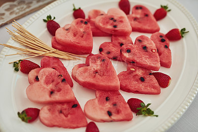 Buy stock photo High angle shot of watermelon cut into heart shapes on a table at a tea party inside
