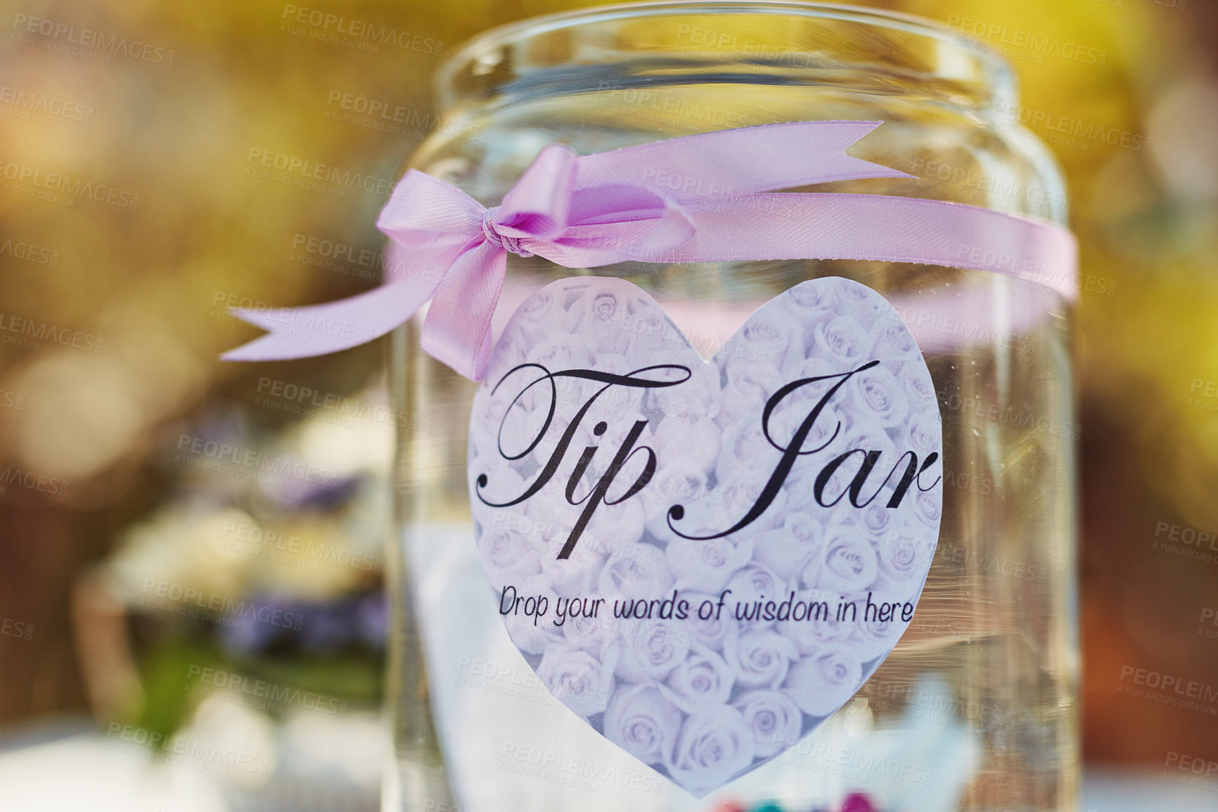 Buy stock photo Closeup shot of a words of wisdom tip jar at a tea party outside