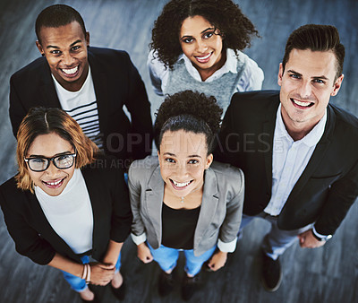 Buy stock photo High angle shot of a group of businesspeople standing together in an office