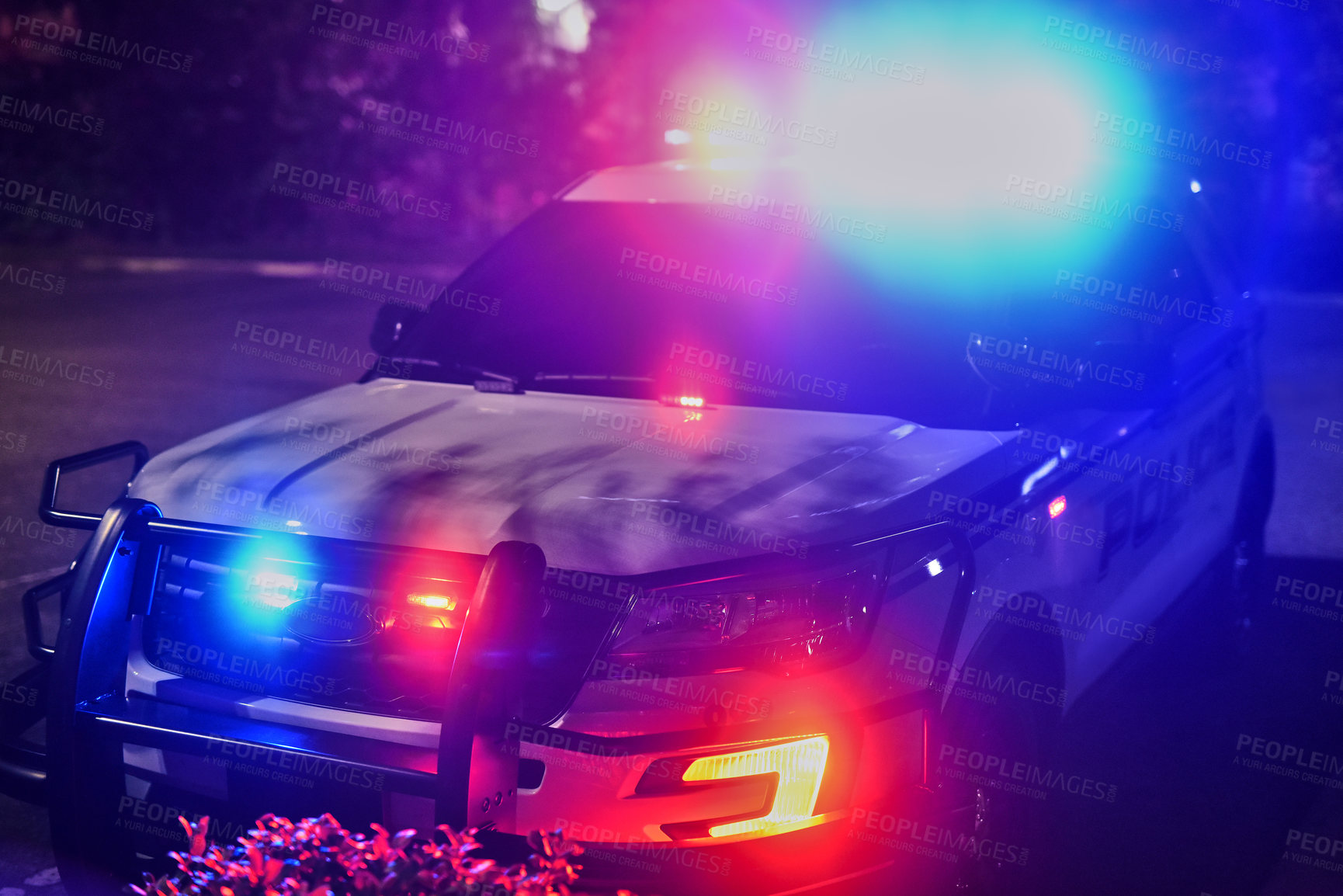 Buy stock photo Cropped shot of a police squad car outside at night