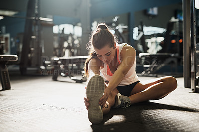 Buy stock photo Gym, fitness and woman stretching legs for exercise, body care and morning training on floor. Workout, bodybuilder or athlete girl on ground for muscle warm up, health and wellness at sports club