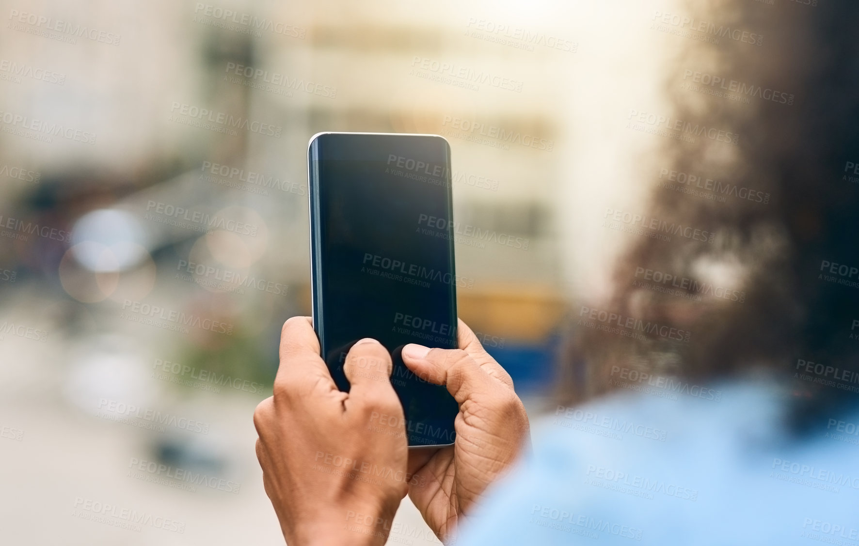 Buy stock photo Cropped shot of an unrecognizable woman using her cellphone while in the city