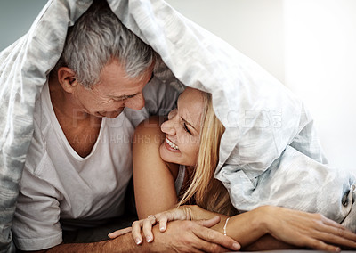 Buy stock photo Shot of an affectionate couple spending the day in bed