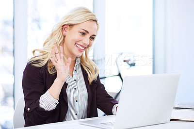 Buy stock photo Cropped shot of an attractive young businesswoman video chatting on her laptop in the office