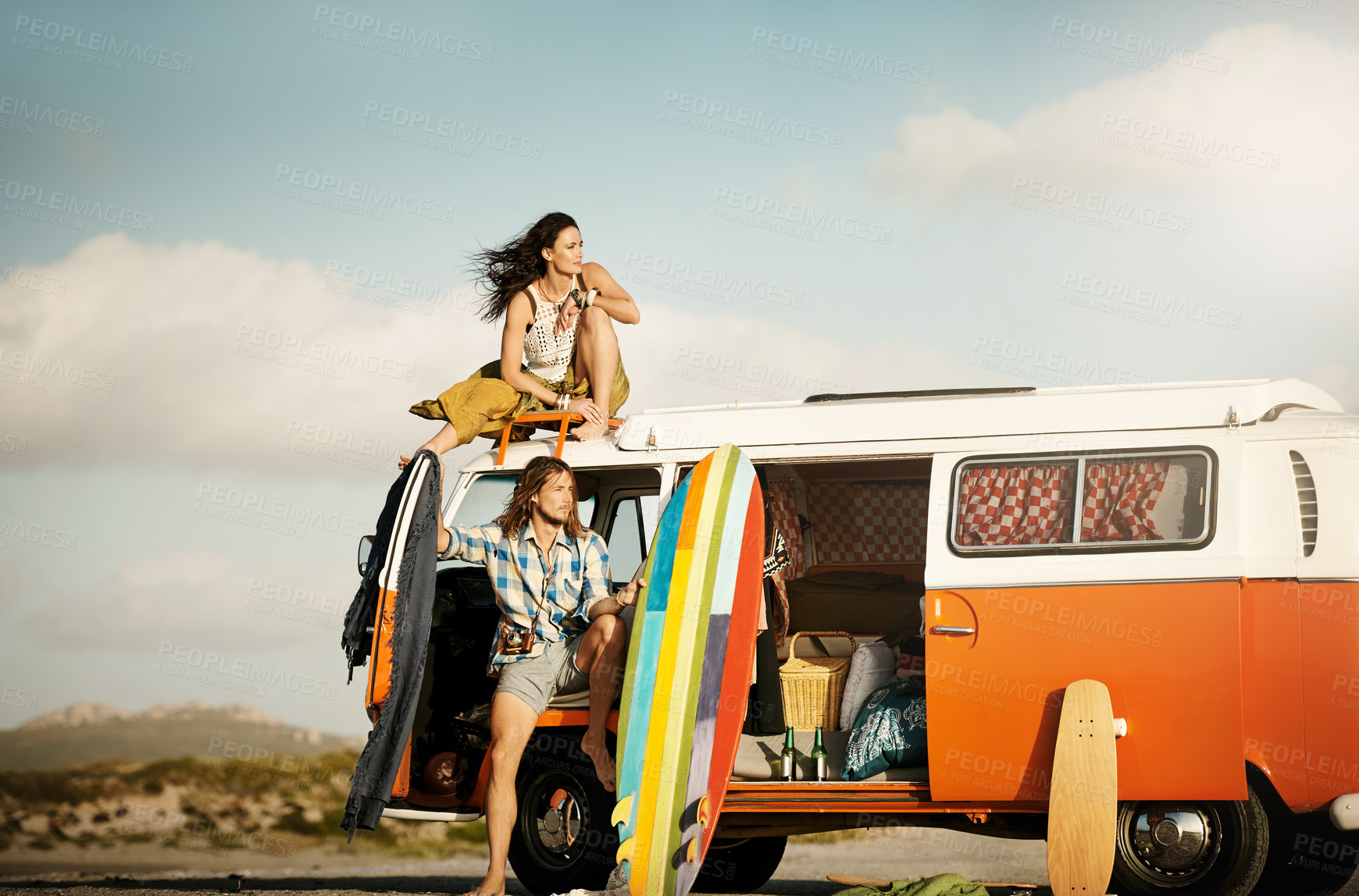 Buy stock photo Shot of an adventurous couple out roadtripping in their mini van