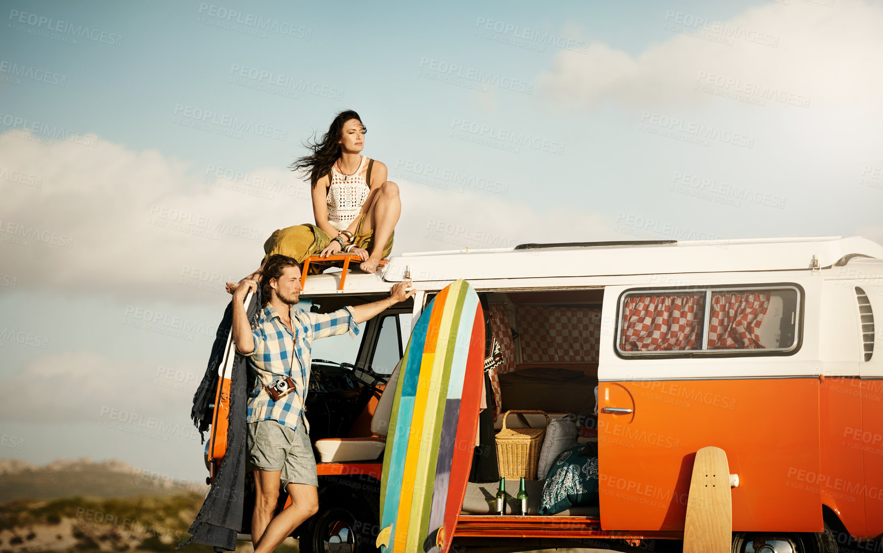 Buy stock photo Shot of an adventurous couple out roadtripping in their mini van