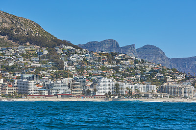Buy stock photo Panorama seascape with clouds, blue sky, and fancy hotel apartment buildings in the background. Sea Point with the Twelve Apostles and Table Mountain National Park in Cape Town, South Africa