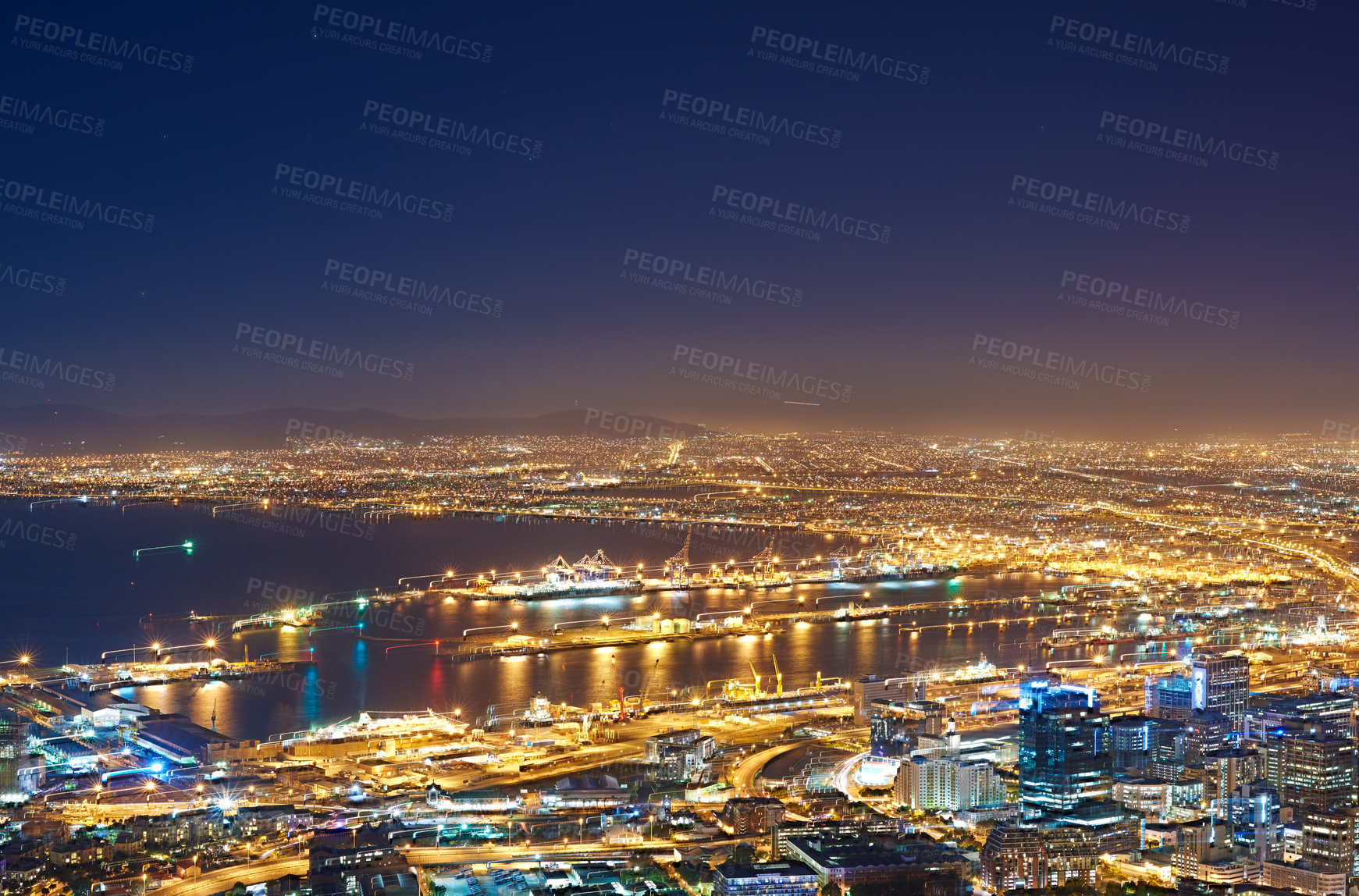 Buy stock photo Aerial view of the night cityscape of Cape Town, South Africa. Wide angle of beautiful scenic view city lights in the evening. High angle view from the signal hill in the darkness in a coastal town.