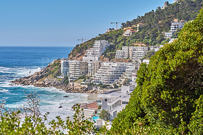 Buy stock photo Clifton, Cape Town, South Africa panorama seascape with clouds, blue sky, hotels, and apartment buildings in the background. Housing development overlooking the beautiful blue ocean peninsula