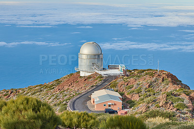Buy stock photo Roque de los Muchachos Observatory in La Palma. A road to an astronomical observatory with blue sky and copy space. Telescope surrounded by greenery and located on an island at the edge of a cliff. 