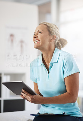 Buy stock photo Cropped shot of a mature female physiotherapist working in her office