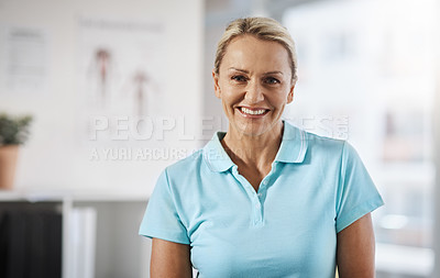Buy stock photo Cropped portrait of a mature female physiotherapist working in her office