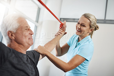 Buy stock photo Cropped shot of a mature female physiotherapist working with a senior male patient in her office