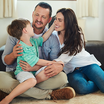Buy stock photo Cropped shot of a young mother and father spending time with their adorable little son in the living room at home