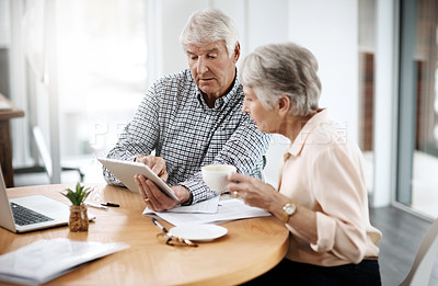 Buy stock photo High angle shot of a senior couple working on their finances at home