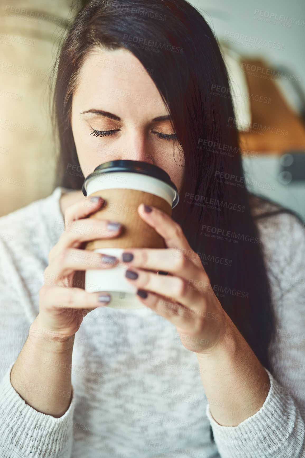Buy stock photo Shot of a young woman drinking coffee in a cafe
