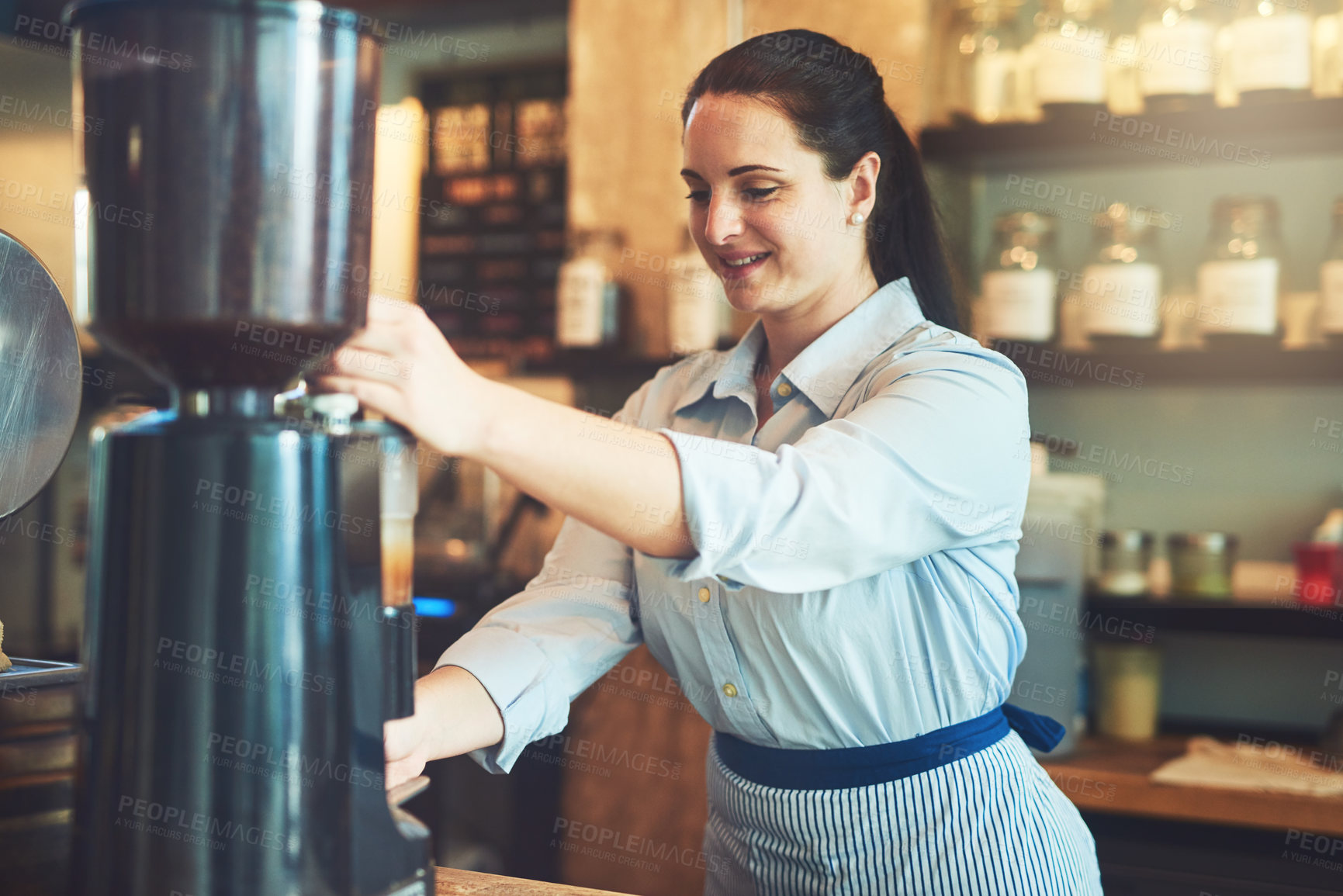Buy stock photo Shot of a young barista working in a cafe