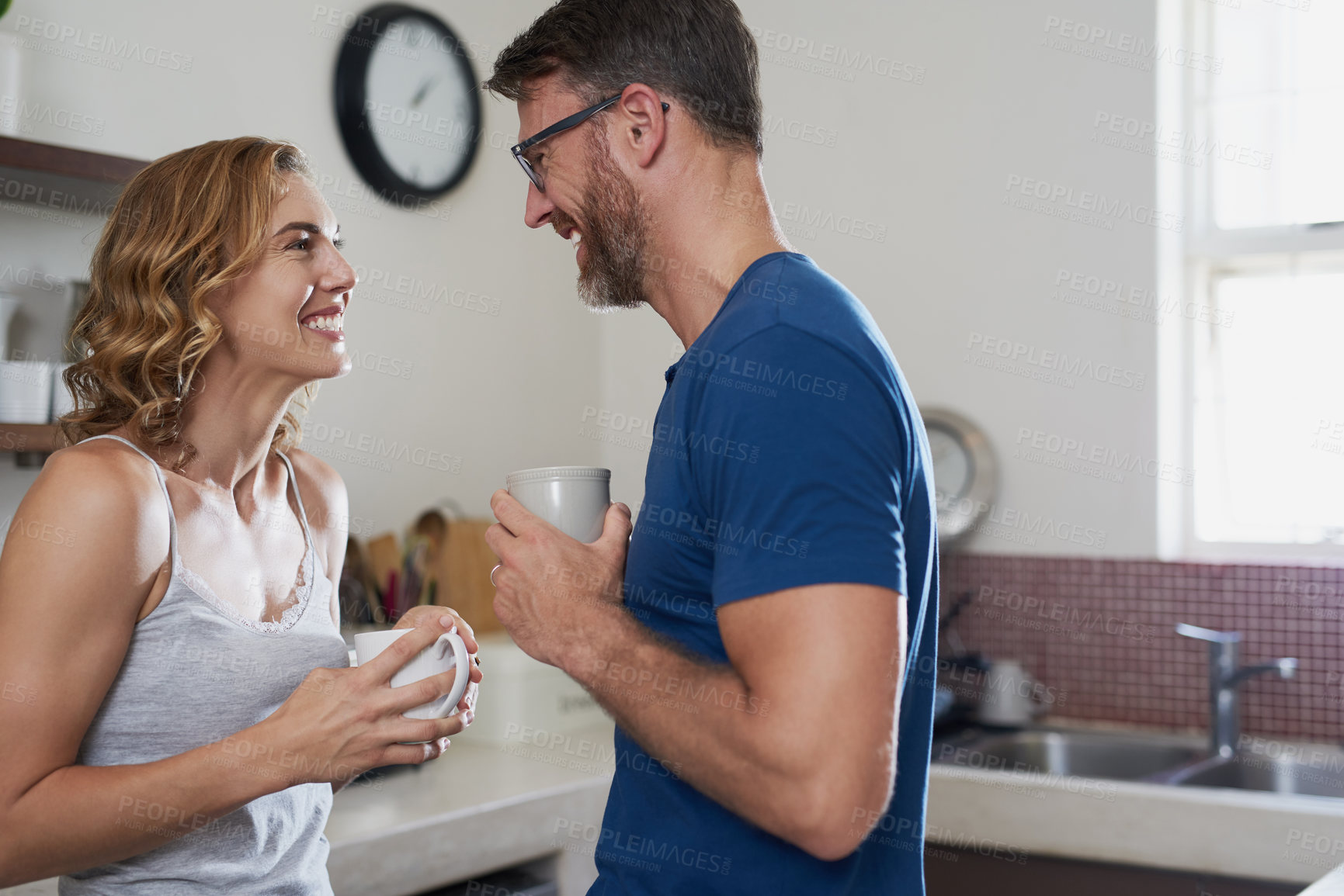 Buy stock photo Shot of a happy middle aged couple having coffee together in the kitchen at home