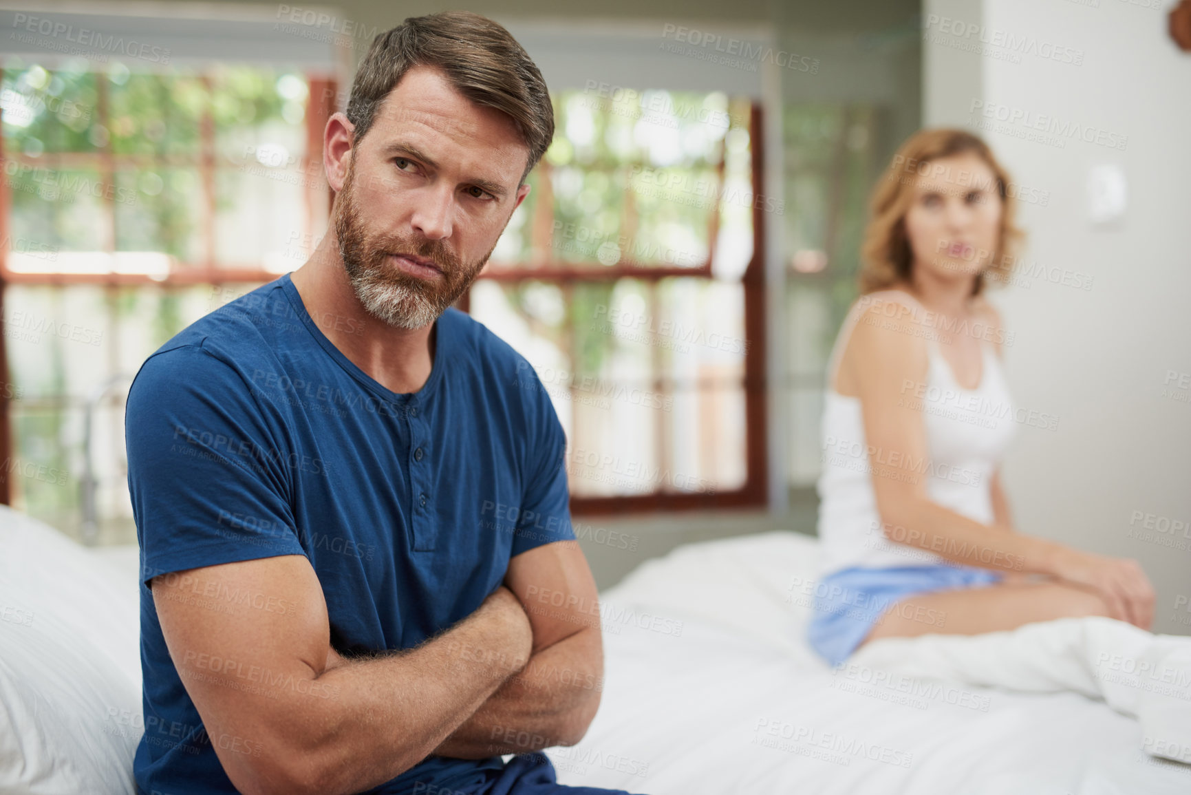 Buy stock photo Shot of a mature couple having marital problems in the bedroom at home