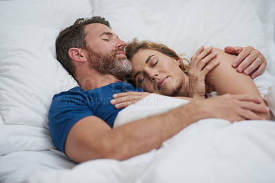 Buy stock photo Shot of a happy middle aged couple relaxing in bed together