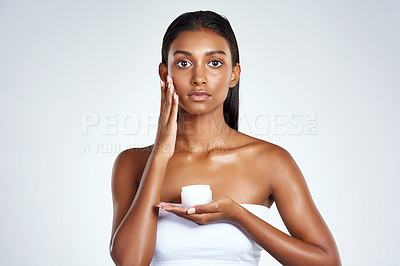 Buy stock photo Indian woman, portrait and skincare product in studio for cream moisturizing, application or dermatology. Female person, hand and white background with wellness lotion or sunscreen, mask or mockup