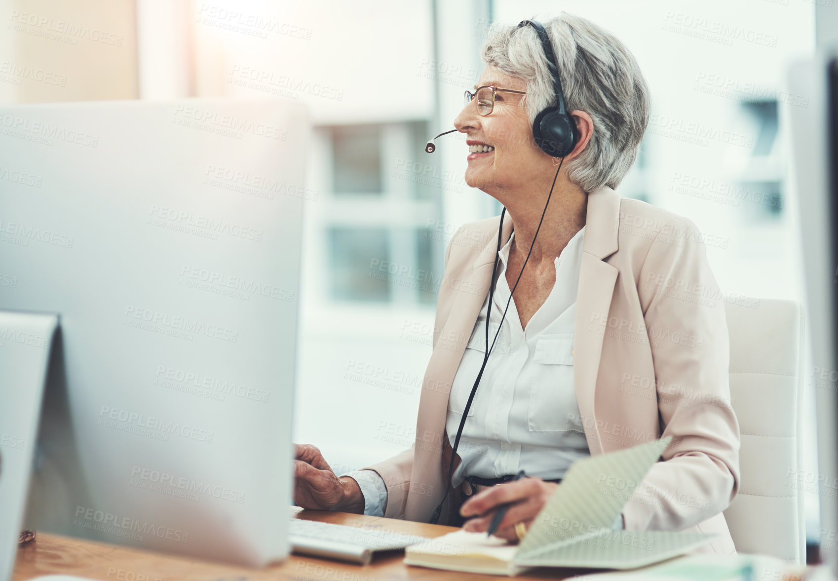 Buy stock photo Shot of a happy senior woman working in a call center