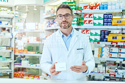 Buy stock photo Cropped portrait of a handsome mature male pharmacist working in a pharmacy