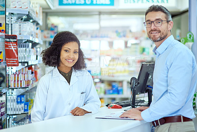 Buy stock photo Cropped portrait of an attractive young female pharmacist helping a male customer in the pharmacy