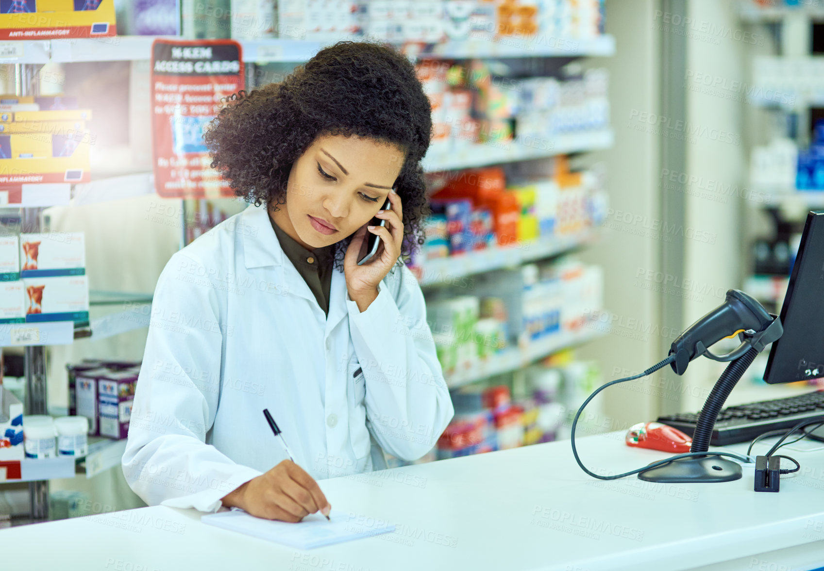 Buy stock photo Cropped shot of an attractive young female pharmacist working in a pharmacy