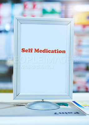 Buy stock photo Shot of a sign with the words ’self medication’ written on it at a pharmacy