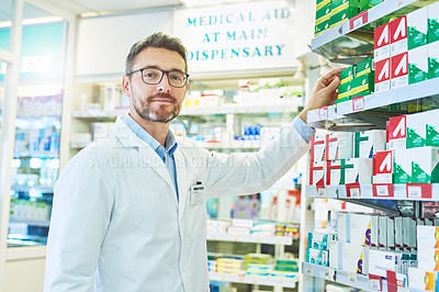 Buy stock photo Shot of a mature pharmacist working in a pharmacy