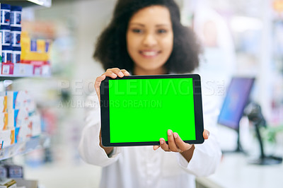 Buy stock photo Shot of a pharmacist holding up a tablet with a chromakey screen