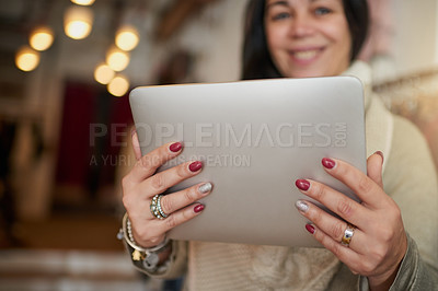 Buy stock photo Closeup shot of a digital tablet in the hands of a female boutique owner