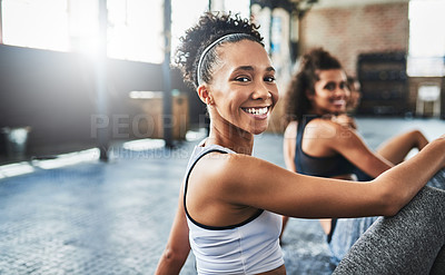 Buy stock photo Shot of a group of happy young women taking a break together at the gym